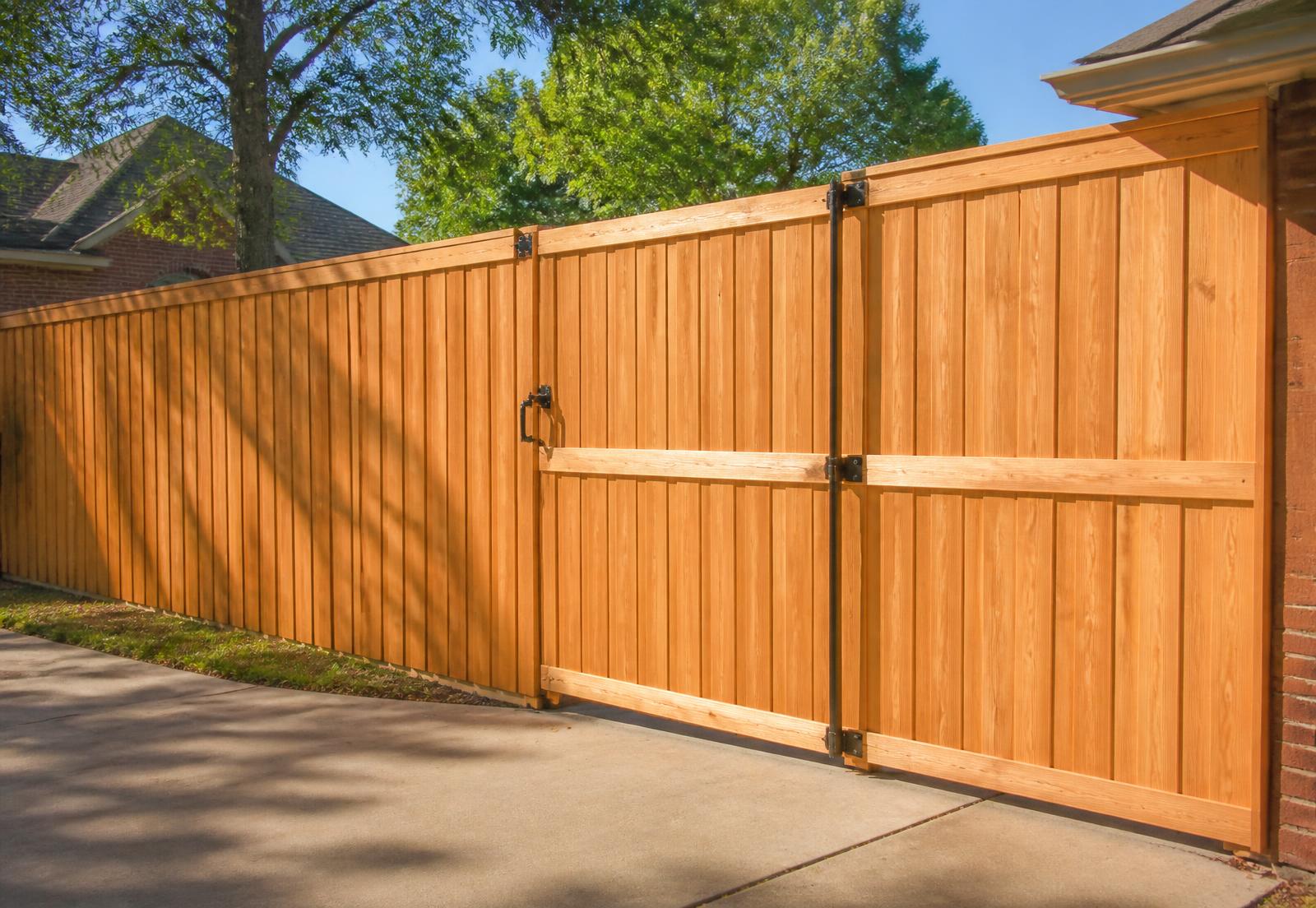 Tall cedar privacy fence with wide double swing gate